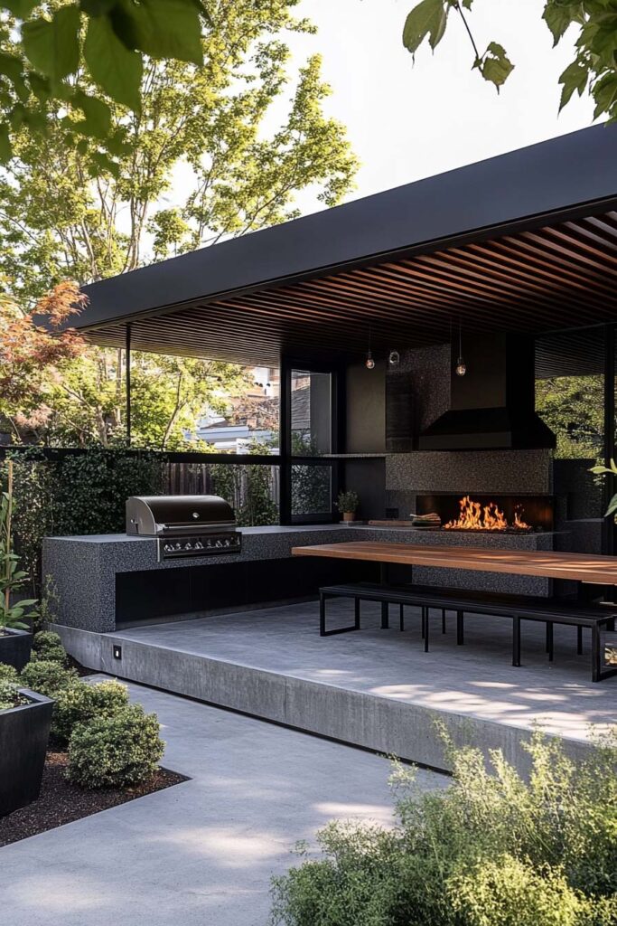 Modern outdoor grill station with concrete counters, built-in fireplace, covered patio, and dining area