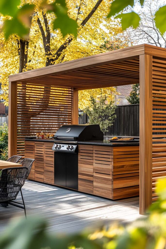Outdoor grill station with wood pergola, slatted privacy panels, built-in grill, and wood cabinetry