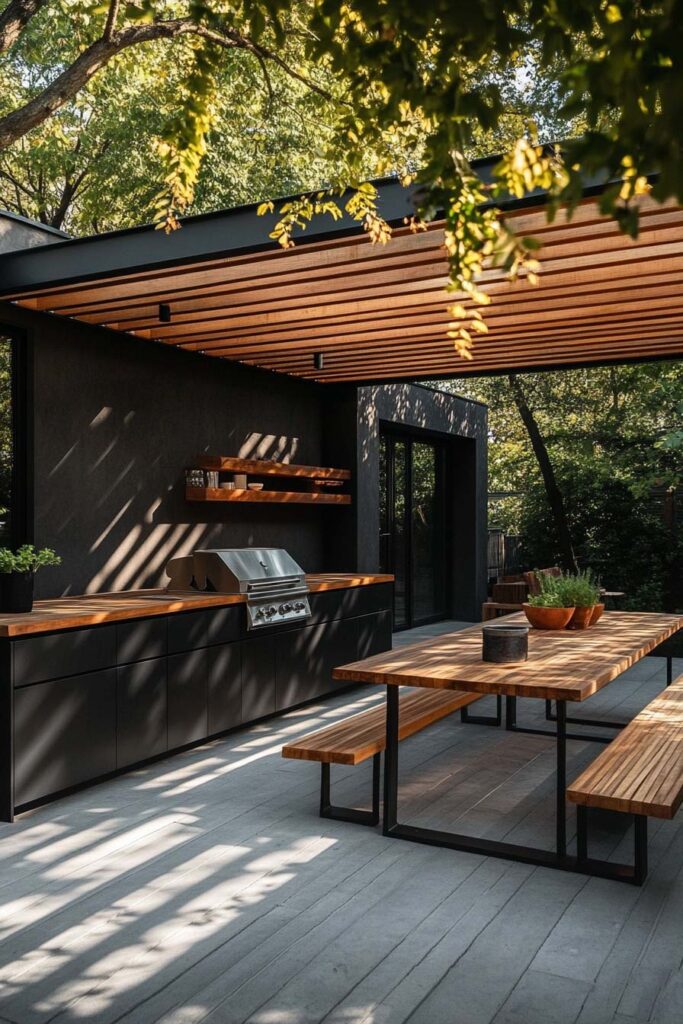 Modern outdoor grill station with black cabinetry, wood countertops, pergola roof, and built-in grill with dining area