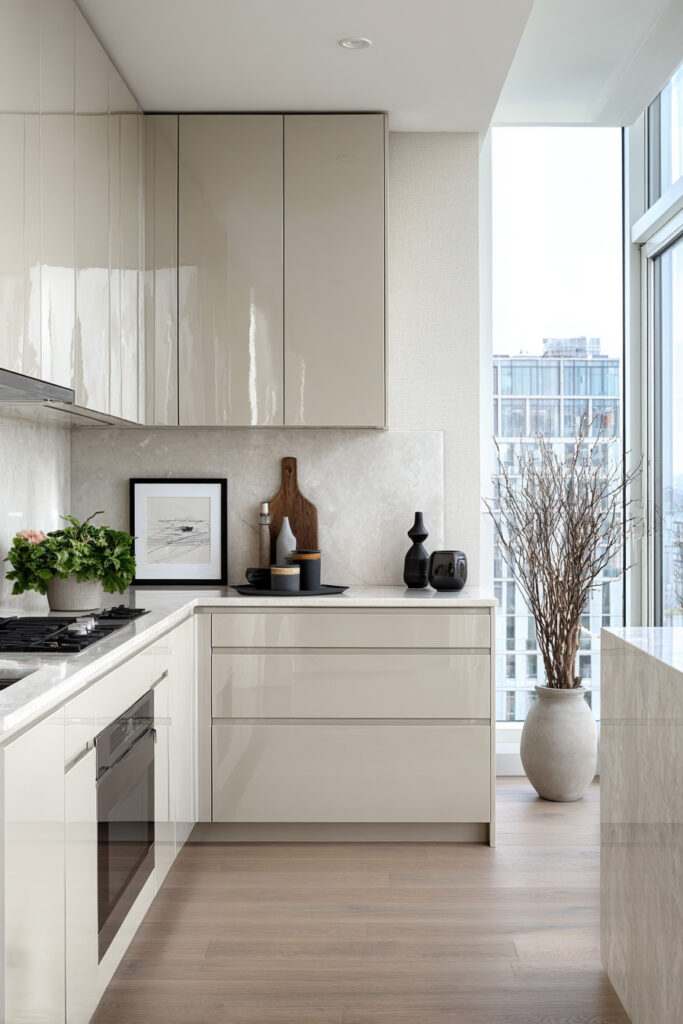Modern neutral kitchen with glossy flat cabinetry, stone backsplash, and minimal styling showing smooth surface kitchen design and dimensional material contrast.