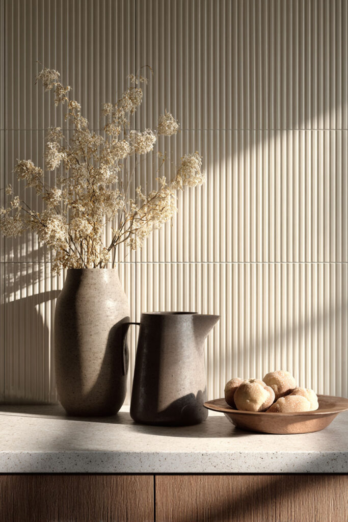 Close-up of fluted ribbed tile backsplash with neutral tones, showing dimensional surface texture in modern kitchen design.