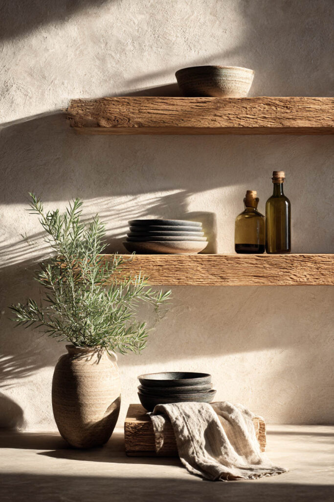 minimal open kitchen shelving with wood shelves, ceramic dishes, and simple organic modern styling with neutral tones